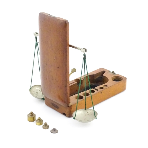 1143 - A late 19th / early 20thC apothecary / jeweller's balance scale within a fitted mahogany case, with ... 