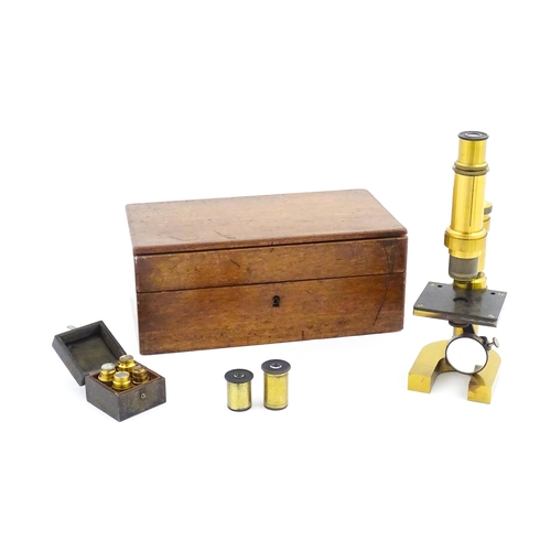 1146 - An early 20thC Leitz microscope, constructed from brass with a cast iron base, the mount stamped 'E.... 