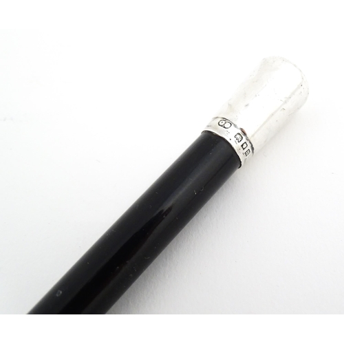 1148 - An early to mid 20thC conductor's baton, of tapering form with ebonised finish and capped with silve... 