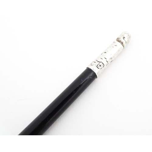 1148 - An early to mid 20thC conductor's baton, of tapering form with ebonised finish and capped with silve... 