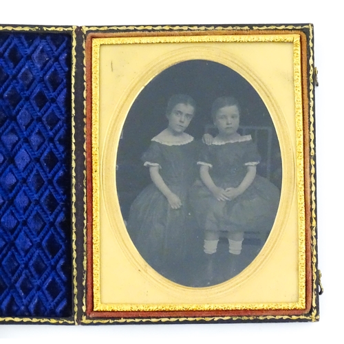 1162 - Two Victorian daguerreotype photographs in folding cases depicting portraits of children, etc. Toget... 