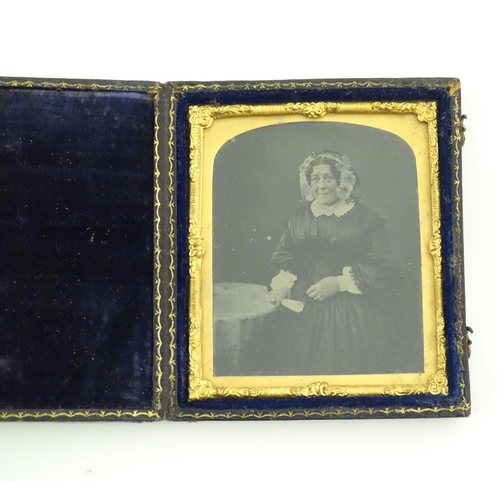 1163 - Four Victorian daguerreotype photographs to include a portrait of a seated woman holding a fan, grou... 