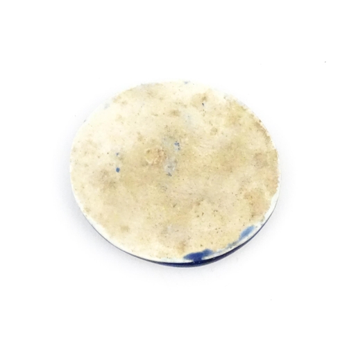 1168 - A Ruskin pottery cabochon of oval form with mottled blue / green detail. Stamped with WHT monogram u... 