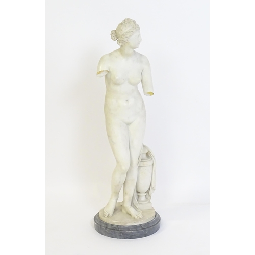 1196 - A composite marble sculpture depicting Aphrodite / Venus with a large urn. Approx. 30