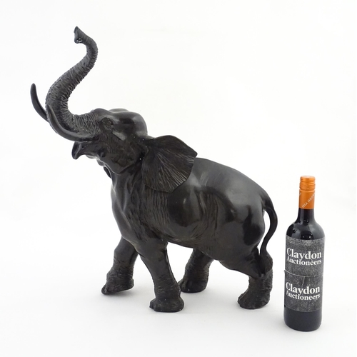 1199 - A 20thC Continental cast and patinated model of an elephant. Approx. 23 1/4