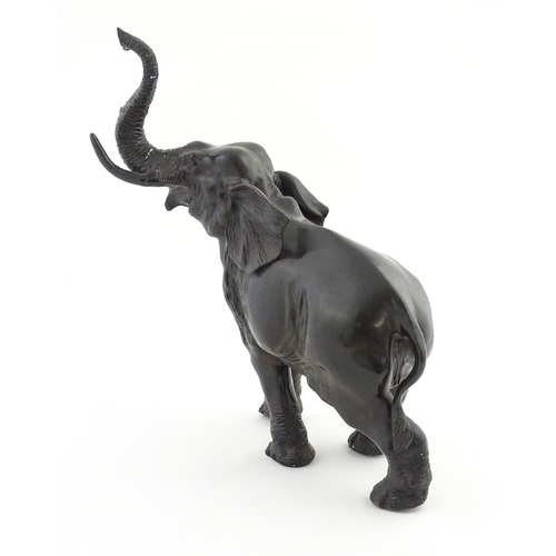 1199 - A 20thC Continental cast and patinated model of an elephant. Approx. 23 1/4