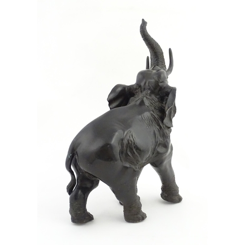 1199 - A 20thC Continental cast and patinated model of an elephant. Approx. 23 1/4