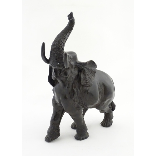 1199 - A 20thC Continental cast and patinated model of an elephant. Approx. 23 1/4