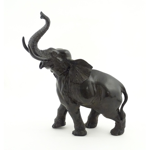 1199 - A 20thC Continental cast and patinated model of an elephant. Approx. 23 1/4