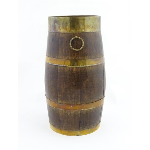 1201 - An early 20thC oak coopered barrel with brass banding and twin ring handles. Approx. 21 1/2