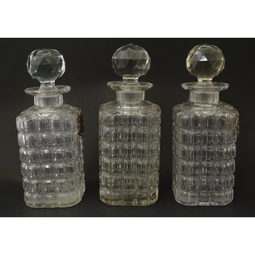 1204 - A late 19th / early 20thC oak tantalus with silver plate mounts, containing three glass decanters an... 