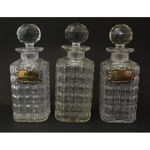 1204 - A late 19th / early 20thC oak tantalus with silver plate mounts, containing three glass decanters an... 