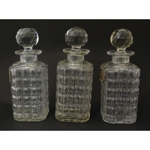 1204 - A late 19th / early 20thC oak tantalus with silver plate mounts, containing three glass decanters an... 