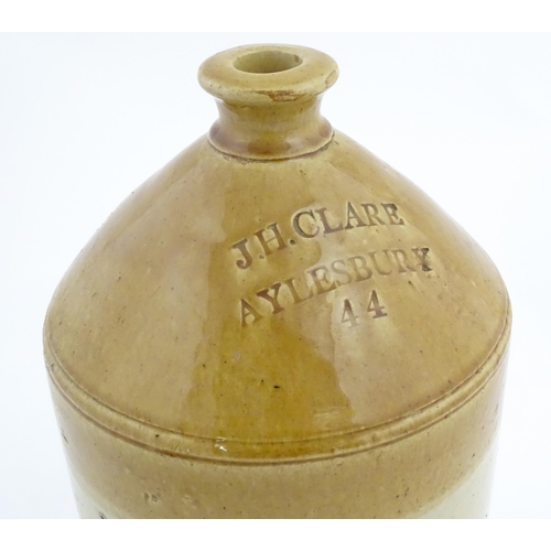 1205 - An early 20thC stoneware two tone flagon with spout lower, marked J. H. Clare Aylesbury 44. Approx. ... 