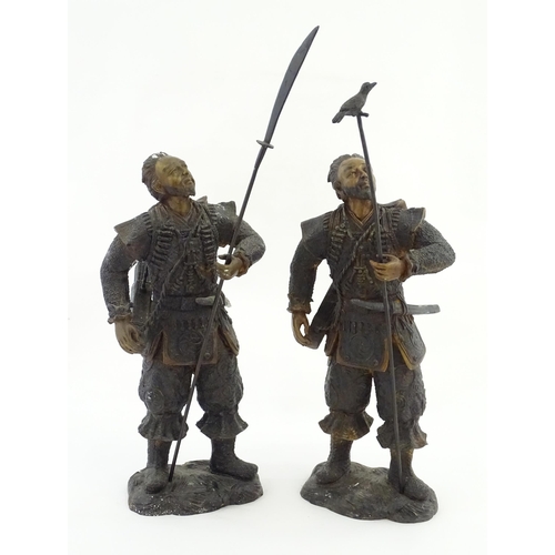 1225 - A pair of Japanese bronze sculptures depicting hunters / warriors, each with a quiver of arrows and ... 