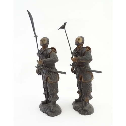 1225 - A pair of Japanese bronze sculptures depicting hunters / warriors, each with a quiver of arrows and ... 