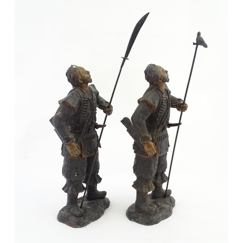 1225 - A pair of Japanese bronze sculptures depicting hunters / warriors, each with a quiver of arrows and ... 