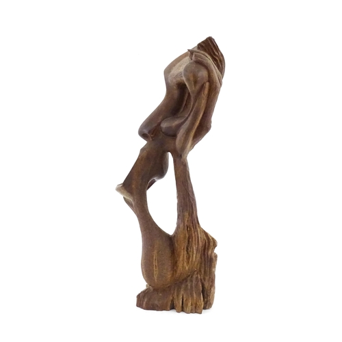 1229 - A 20thC carved wood sculpture modelled as an abstract face. Approx. 16