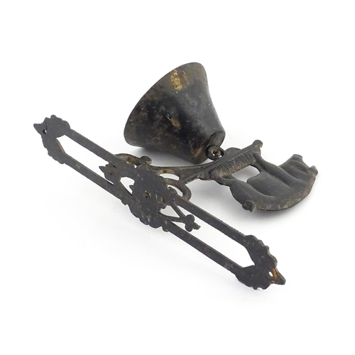 1243 - A 20thC cast wall hanging exterior bell surmounted by a pig. Approx. 15 3/4