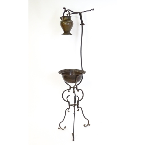 1247 - A wrought iron washstand, the scrolling tripod base with copper bowl / basin, the upstand with hangi... 