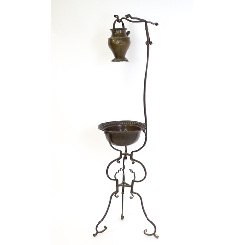 1247 - A wrought iron washstand, the scrolling tripod base with copper bowl / basin, the upstand with hangi... 