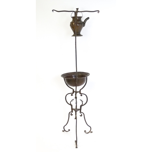 1247 - A wrought iron washstand, the scrolling tripod base with copper bowl / basin, the upstand with hangi... 