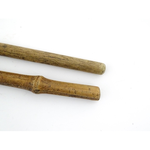 1251 - Four walking sticks, comprising a native tribal example with knop handle, an oriental stick with car... 