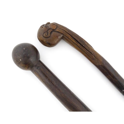 1251 - Four walking sticks, comprising a native tribal example with knop handle, an oriental stick with car... 