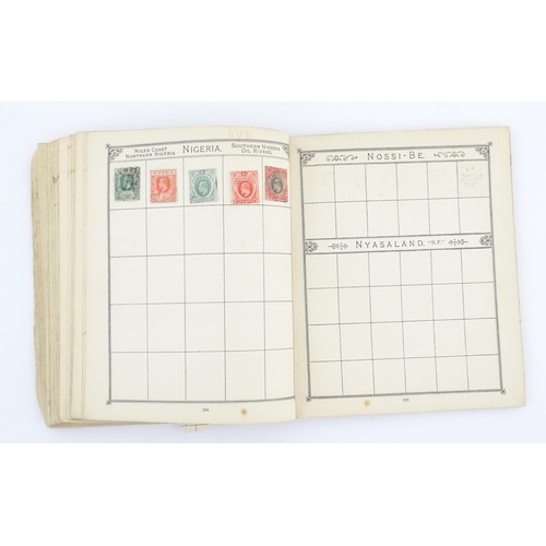 1194 - An early 20thC postage stamp album, containing numerous affixed worldwide stamps including 19thC and... 