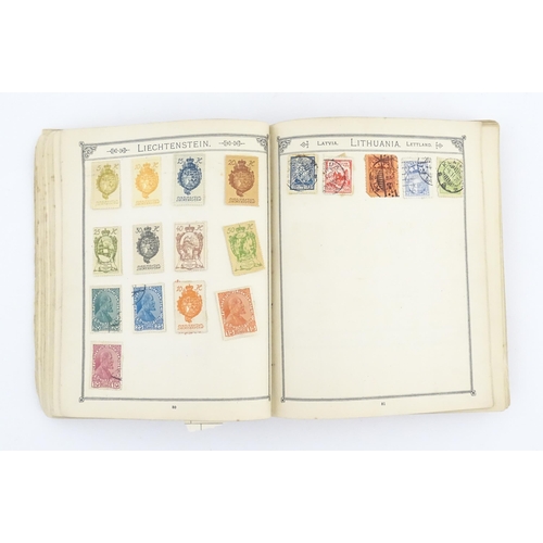 1194 - An early 20thC postage stamp album, containing numerous affixed worldwide stamps including 19thC and... 