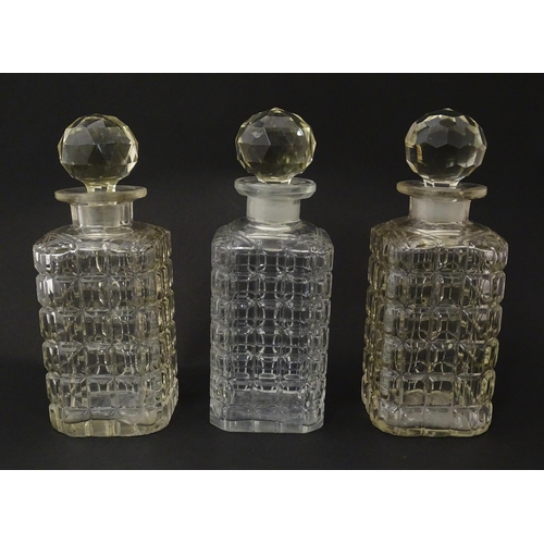 1198 - A 20thC oak tantalus with three glass decanters. Approx. 12