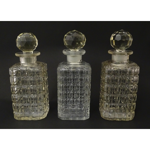 1198 - A 20thC oak tantalus with three glass decanters. Approx. 12