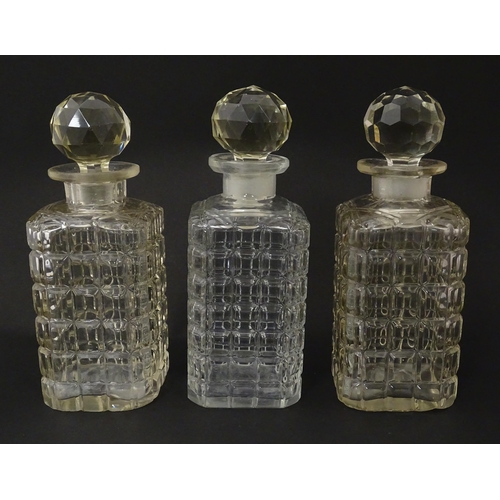 1198 - A 20thC oak tantalus with three glass decanters. Approx. 12