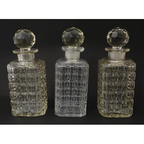 1198 - A 20thC oak tantalus with three glass decanters. Approx. 12