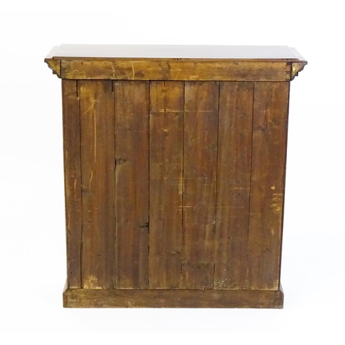 1367 - An early 20thC walnut bookcase with a moulded cornice above a dentil craved frieze with two glazed d... 