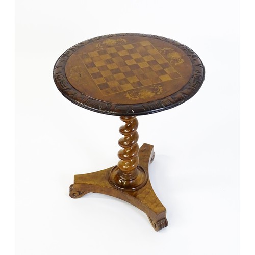 1396 - A 19thC tripod table with a circular top inlaid with a chessboard, floral decoration and a carved su... 