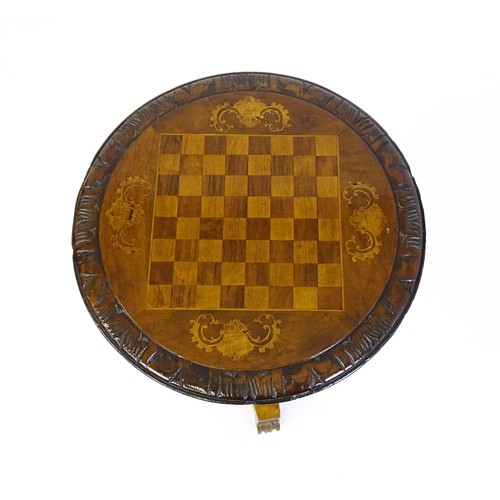 1396 - A 19thC tripod table with a circular top inlaid with a chessboard, floral decoration and a carved su... 