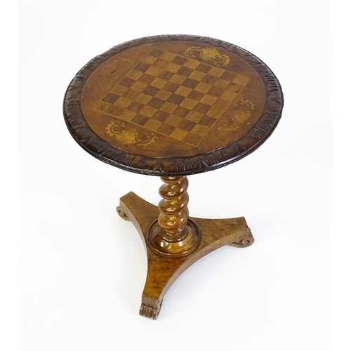 1396 - A 19thC tripod table with a circular top inlaid with a chessboard, floral decoration and a carved su... 