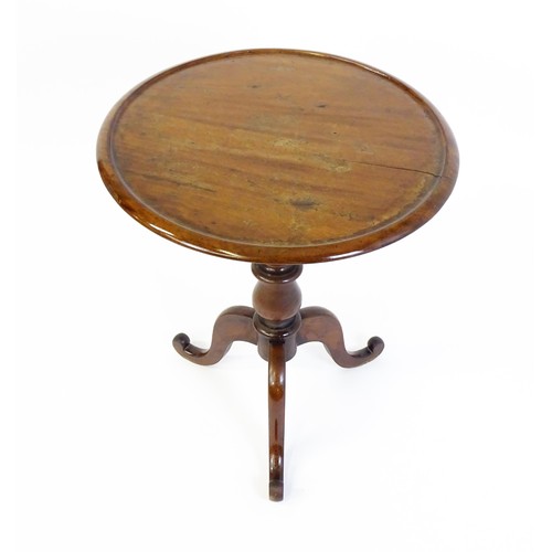 1353 - A Victorian mahogany tripod table with a circular dished top above a turned pedestal and three cabri... 