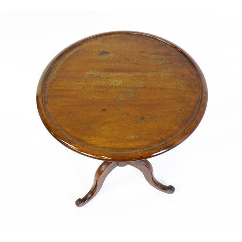 1353 - A Victorian mahogany tripod table with a circular dished top above a turned pedestal and three cabri... 