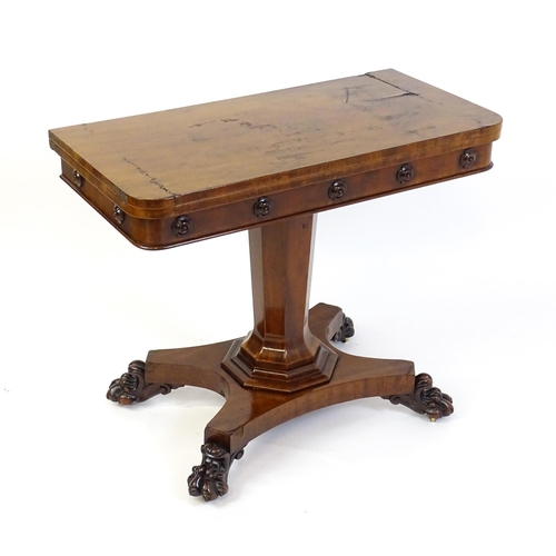 1331 - A 19thC mahogany card table with a rectangular top above applied, carved roundel decoration with a c... 