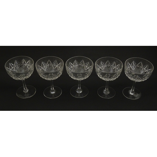 207 - Five cut glass champagne coupes together with five cut glass pedestal wine glasses. Approx 4 1/2