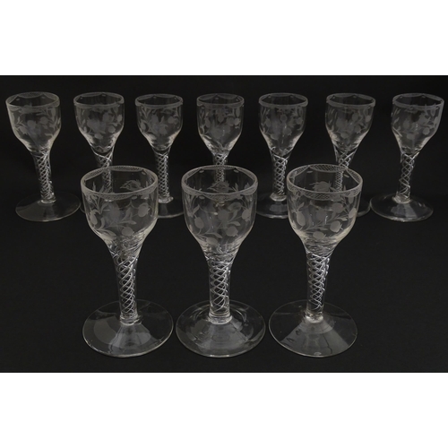 244 - Ten Georgian drinking glasses with air twist detail to stems, the bowls engraved with floral and fol... 