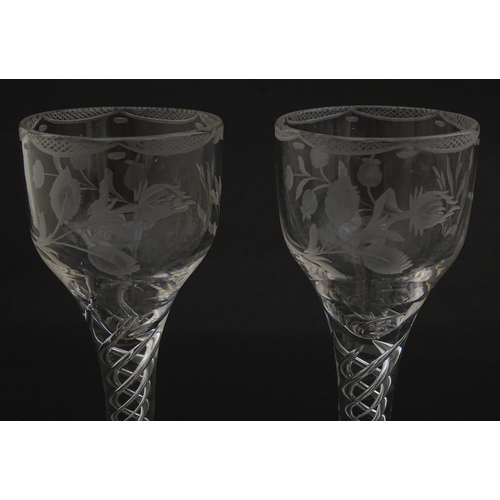 244 - Ten Georgian drinking glasses with air twist detail to stems, the bowls engraved with floral and fol... 