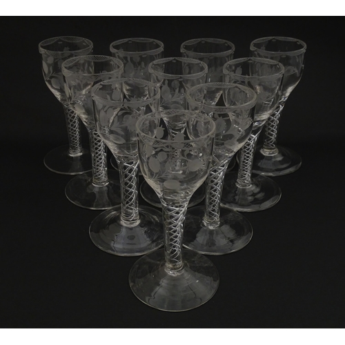 244 - Ten Georgian drinking glasses with air twist detail to stems, the bowls engraved with floral and fol... 