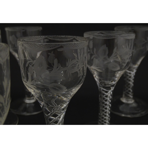 244 - Ten Georgian drinking glasses with air twist detail to stems, the bowls engraved with floral and fol... 