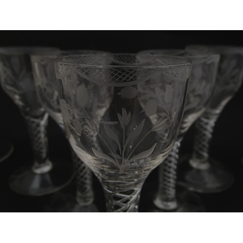 244 - Ten Georgian drinking glasses with air twist detail to stems, the bowls engraved with floral and fol... 