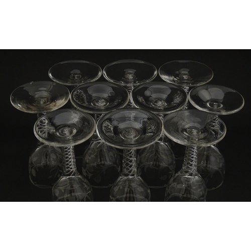 244 - Ten Georgian drinking glasses with air twist detail to stems, the bowls engraved with floral and fol... 