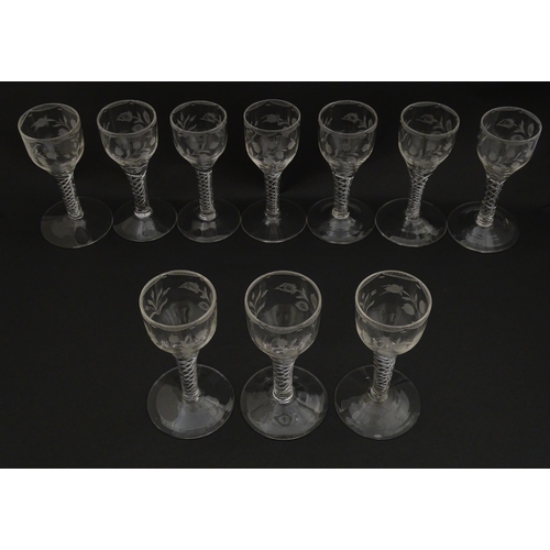 244 - Ten Georgian drinking glasses with air twist detail to stems, the bowls engraved with floral and fol... 