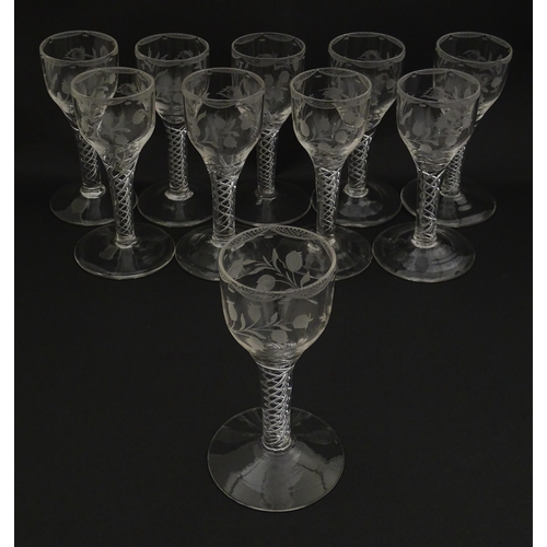 244 - Ten Georgian drinking glasses with air twist detail to stems, the bowls engraved with floral and fol... 